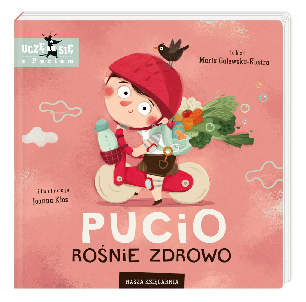 Okładka rysunkowa. Na różowym tle chłopiec w czerwonym kasku jedzie na rowerku z plecakiem pełnym warzyw i owoców