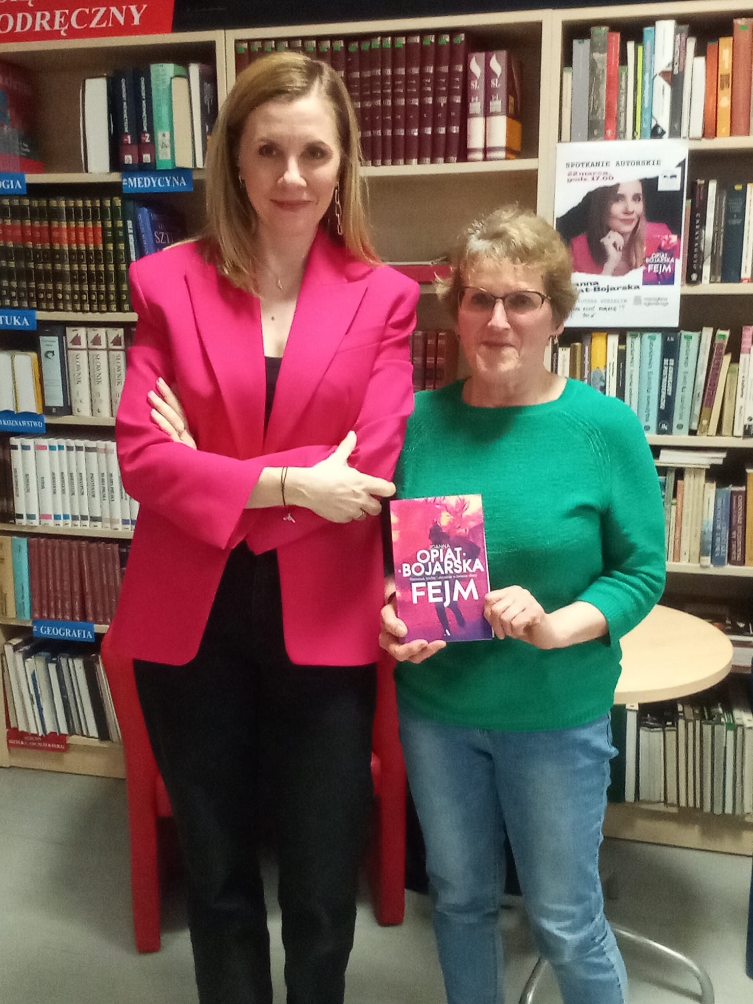 zytelnia biblioteki, spotkanie autorskie z Joanną Opiat-Bojarską, dwie kobiety stoją obok siebie i pozują do zdjęcia